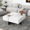 White geometric coffee table in a modern living room scene.