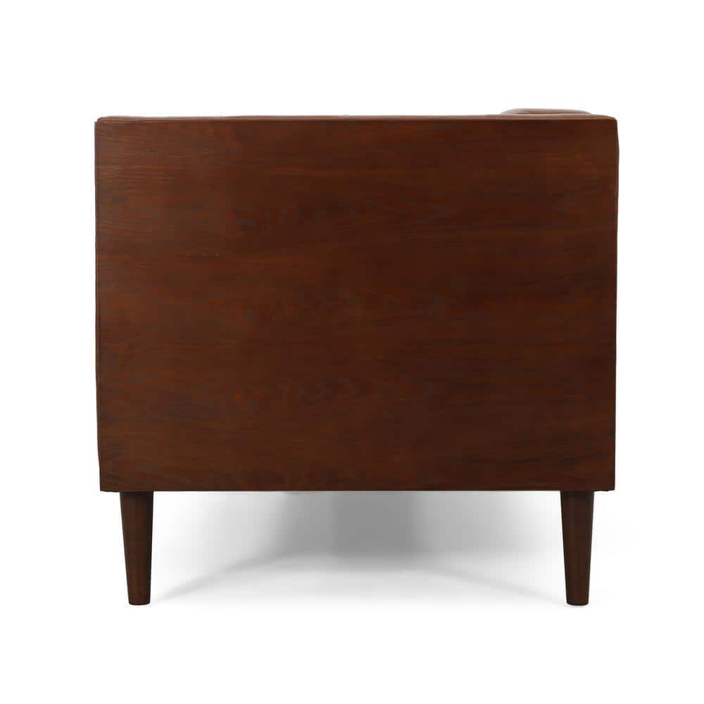 Side view of a cognac brown faux leather sofa showing a dark wood side panel.