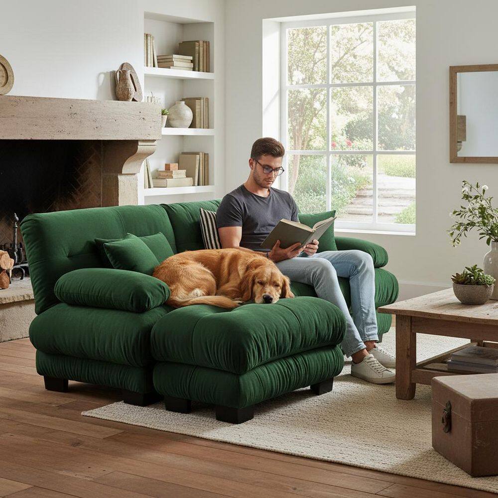 Man relaxing on a green sectional sofa with a dog.