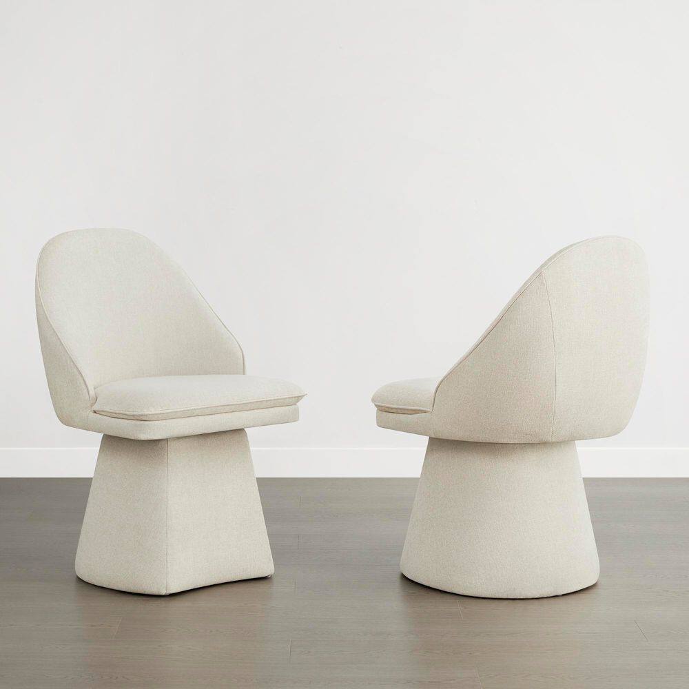 Two cream linen upholstered swivel dining chairs shown from different angles.