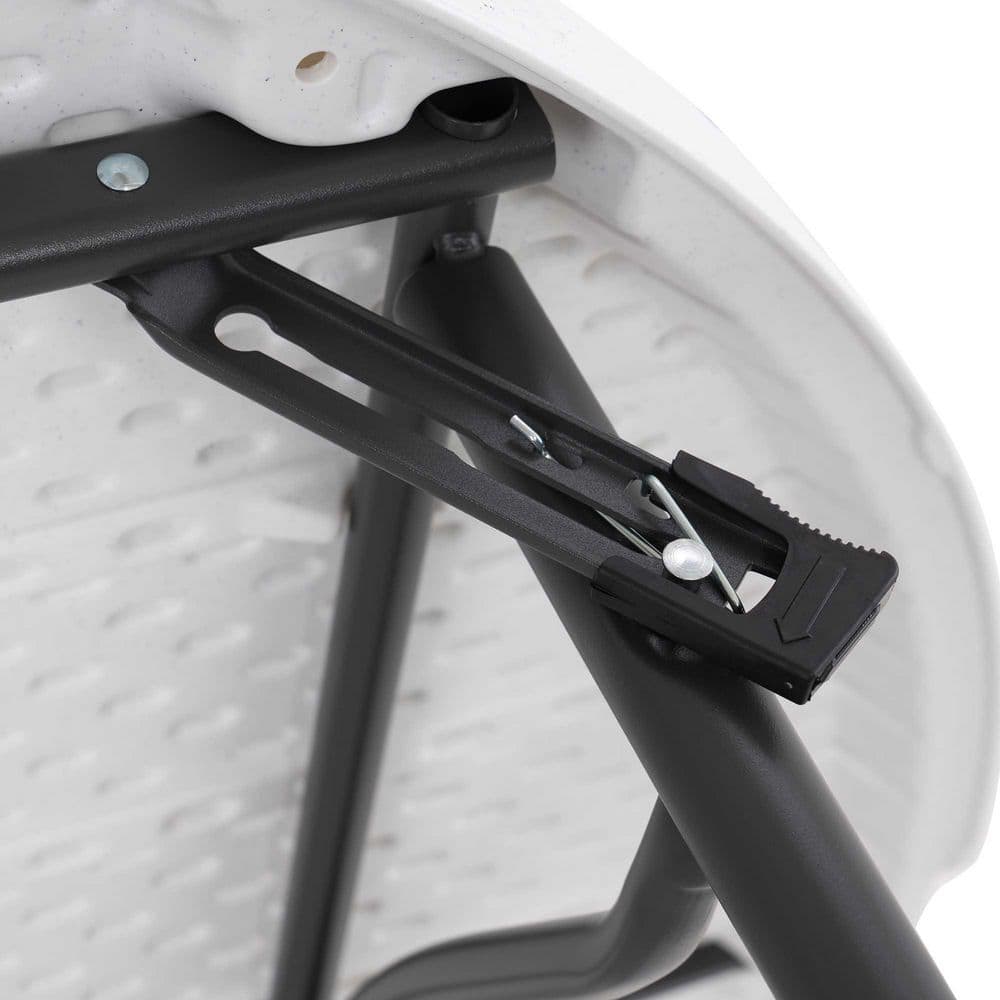 Close-up of the metal frame and folding mechanism of the table.