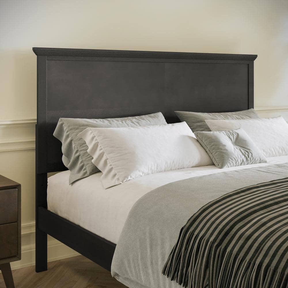 Close-up of the headboard and bedding of the Carnegy Avenue Gray Wood Frame Queen Platform Bed.