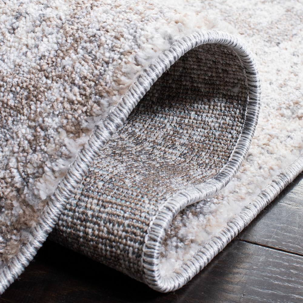 Ivory and Grey Abstract 6' x 9' Synthetic Area Rug