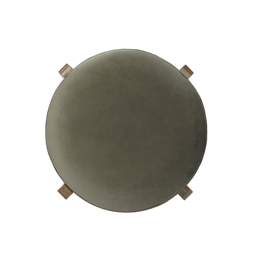 Close-up of the round green upholstered seat of a bar stool.