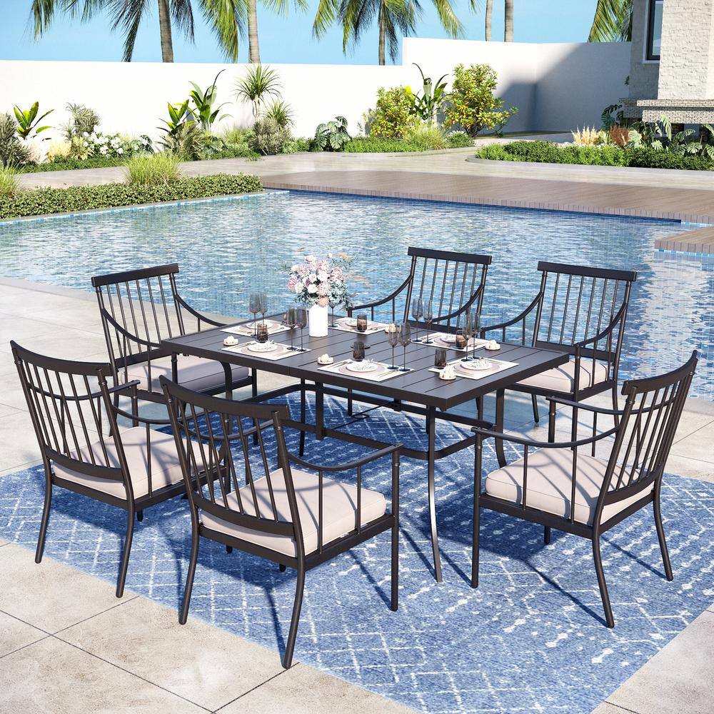 Outdoor dining set with chairs and table by a swimming pool.