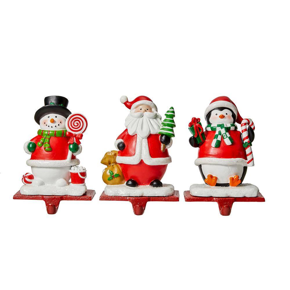 Glitzhome 6.25 in. H Set of 3 Resin Santa, Snowman, Penguin Stocking ...