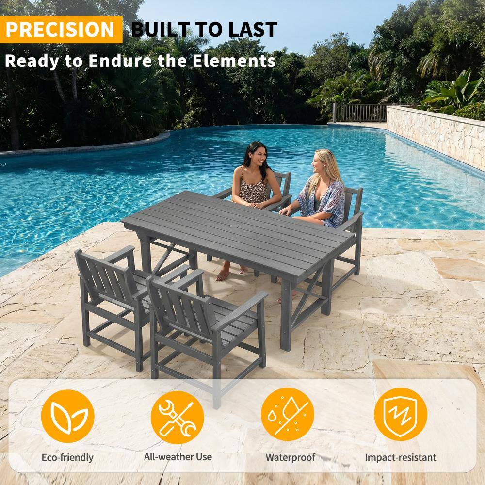Group of gray dining chairs around a wooden table by a pool.