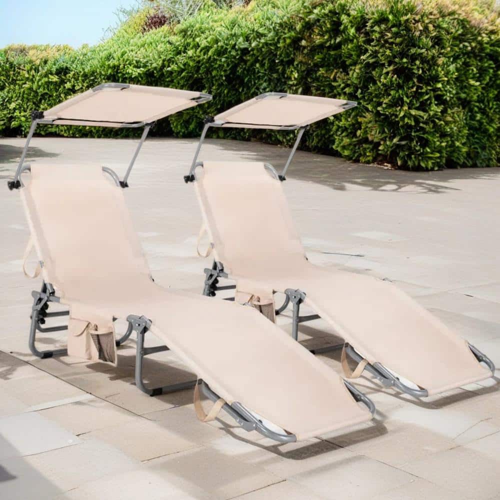 Two Cubilan brown adjustable outdoor lounger chaise lounges in an outdoor patio setting.