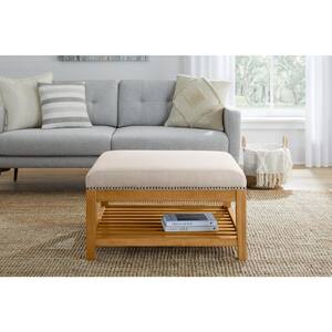 Hayesbrook Biscuit Beige Upholstered Square Ottoman with Patina Wood Accents (32" W)
