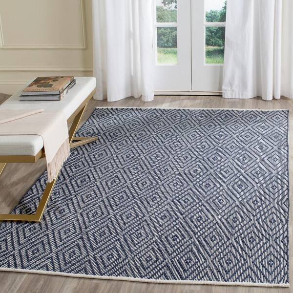 https://images.thdstatic.com/productImages/e784d0b2-64c7-4e7c-bd79-196e7eb47140/svn/navy-ivory-safavieh-area-rugs-mtk811c-4-31_600.jpg