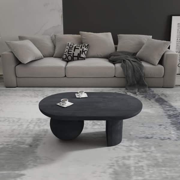 Uri 38 in. Sandblasted Black Oval Mango Wood Coffee Table with Full and Half Spherical Leg