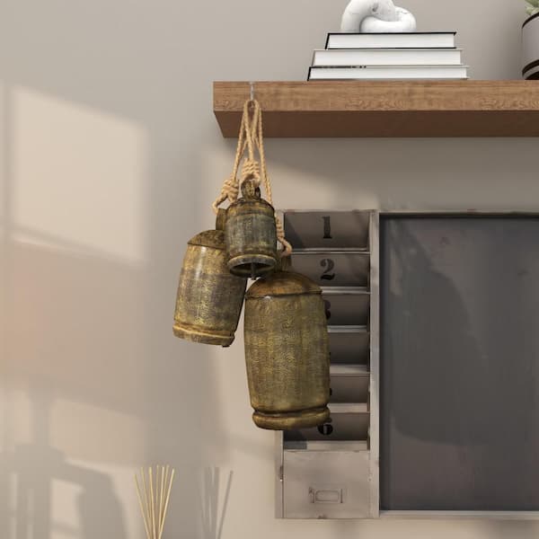 Litton Lane Gold Metal Tibetan Inspired Cylindrical Decorative Cow