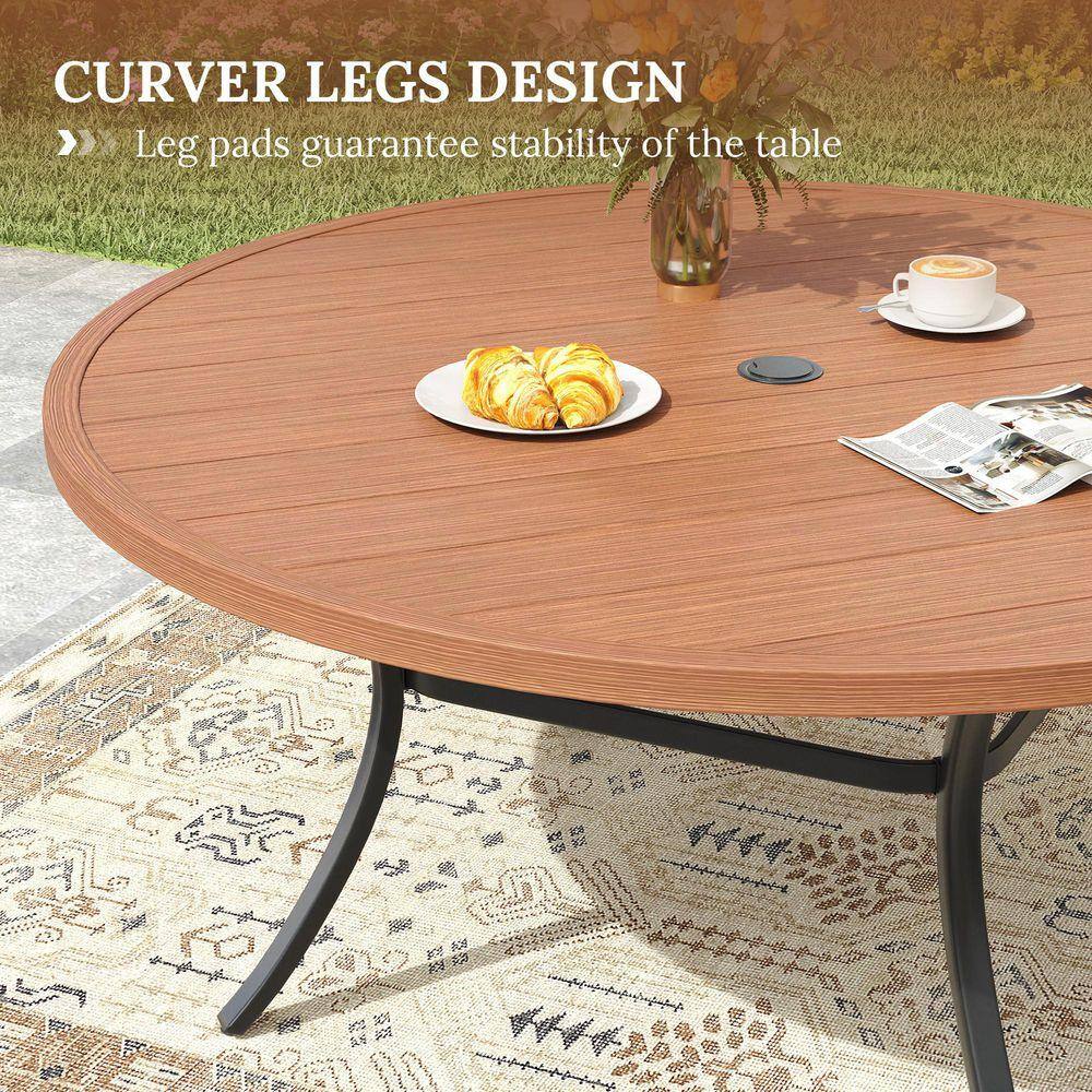 Round outdoor patio table with curved legs set outdoors.