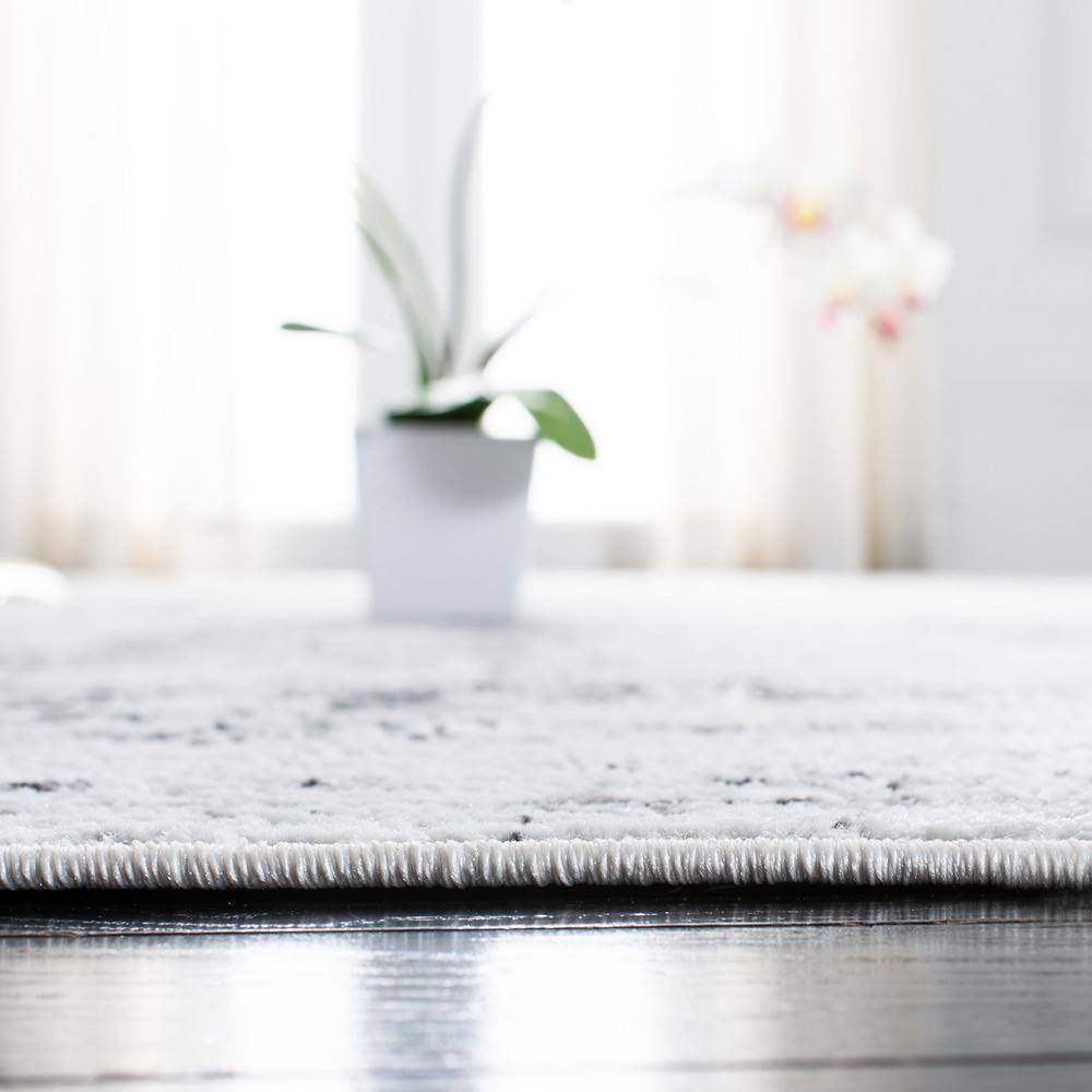 Ivory and Grey Abstract Round Synthetic Rug, 3' x 5'