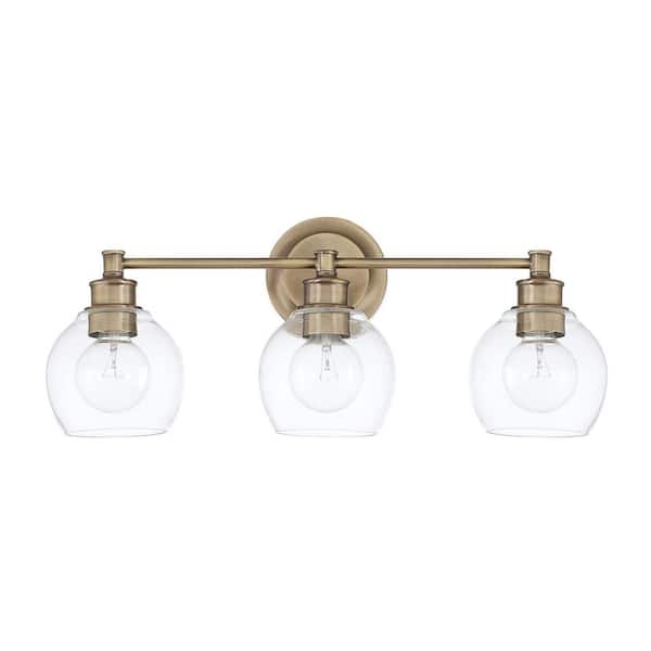 Capital Lighting Fixture Company Mid Century 23.5 in. W x 10 in. H x 7 in. E 3-Light Aged Brass Vanity Light with Clear Glass