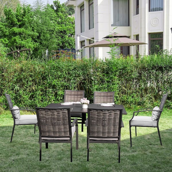 7-Piece Metal Outdoor Dining Set with Light Gray Cushions and Woven Rattan Chairs