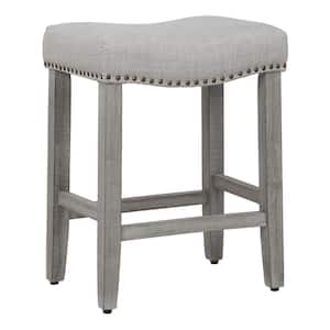 Jameson 24 in Counter Height Antique Gray Wood Backless Nailhead Trim Barstool with Upholstered Gray Linen Saddle Seat