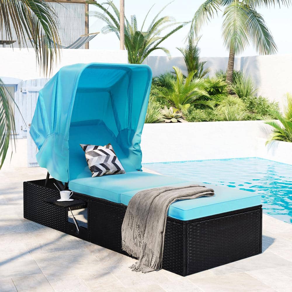 Black Wicker Outdoor Chaise Lounge with Blue Cushions and Canopy