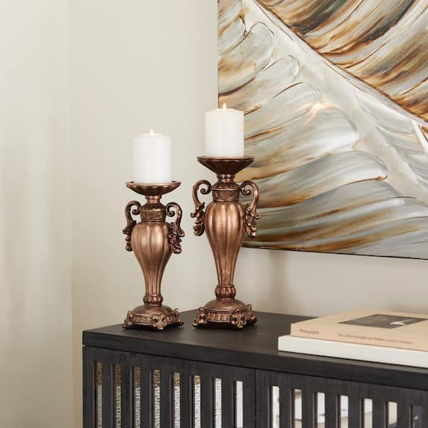 Litton Lane Brass Polystone Scroll Pillar Candle Holder (Set of 2)