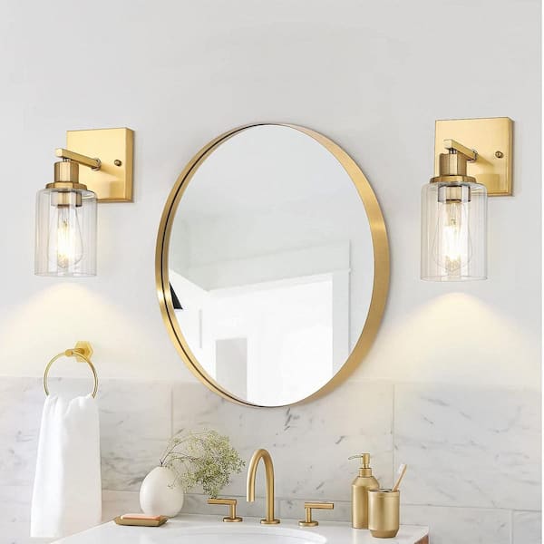 Brass sconces above bathroom vanity