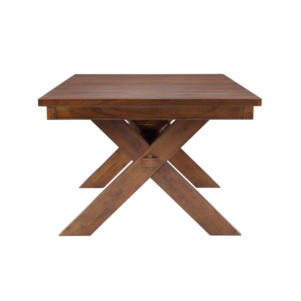 Front view of the X-shaped trestle base of a dark hazelnut brown wood dining table.