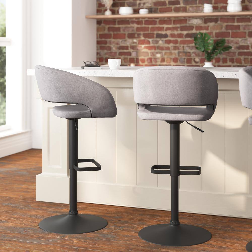 Two gray fabric bar stools placed in a modern kitchen setting.