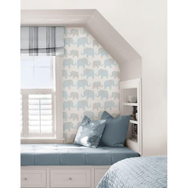 Patterned wallpaper and blind in teenager girls bedroom with white