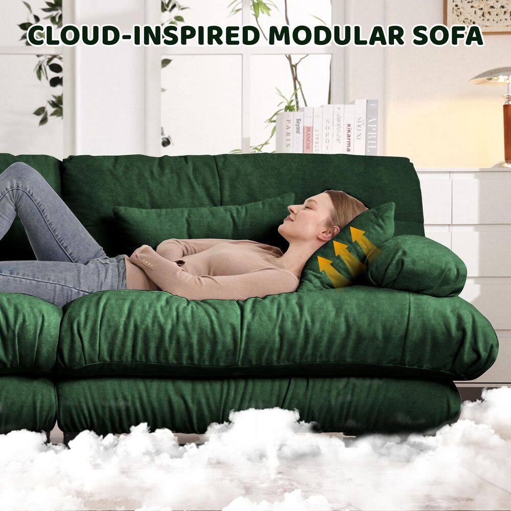Woman relaxing on a modular green sofa.
