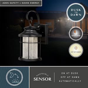 Melbourne 1-Light LED Dusk to Dawn Bronze Coastal Outdoor Wall Lantern Clear Glass