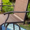Close-up of the armrest and textured seat of a brown metal outdoor bar stool.