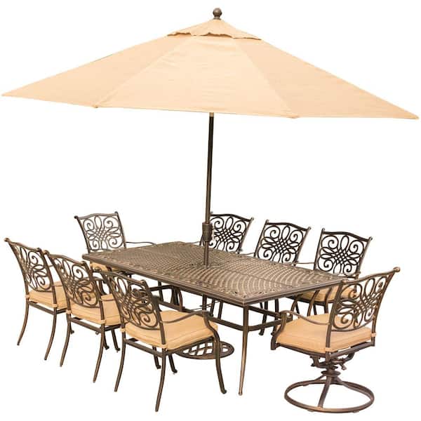 Hanover 9-Piece Outdoor Dining Set with Rectangular Cast Table and 2 Swivels with Natural Oat Cushions, Umbrella and Base