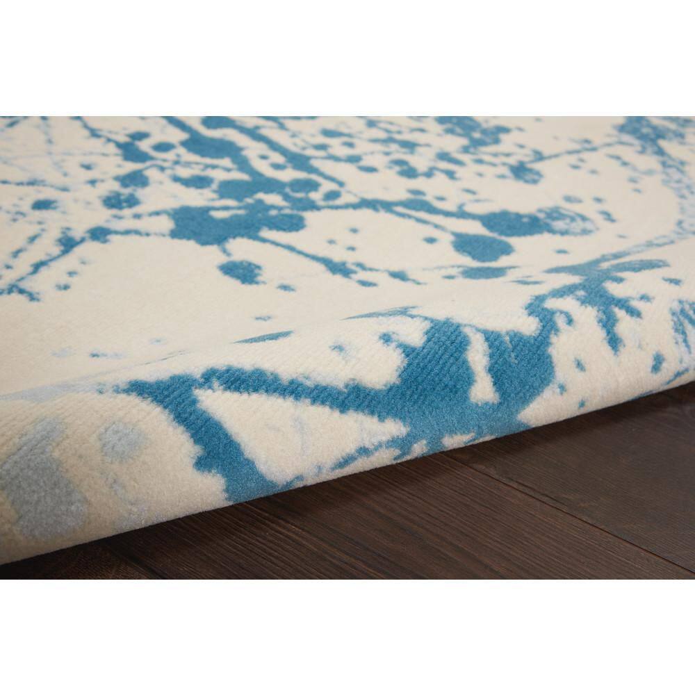 Ivory and Blue Abstract Synthetic 4' x 6' Easy-Care Area Rug