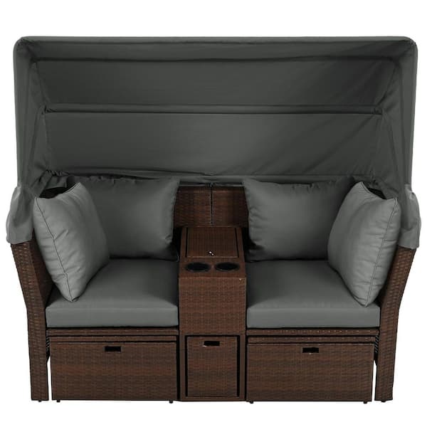 Brown Wicker Outdoor Day Bed with Gray Foldable Awning and Cushions
