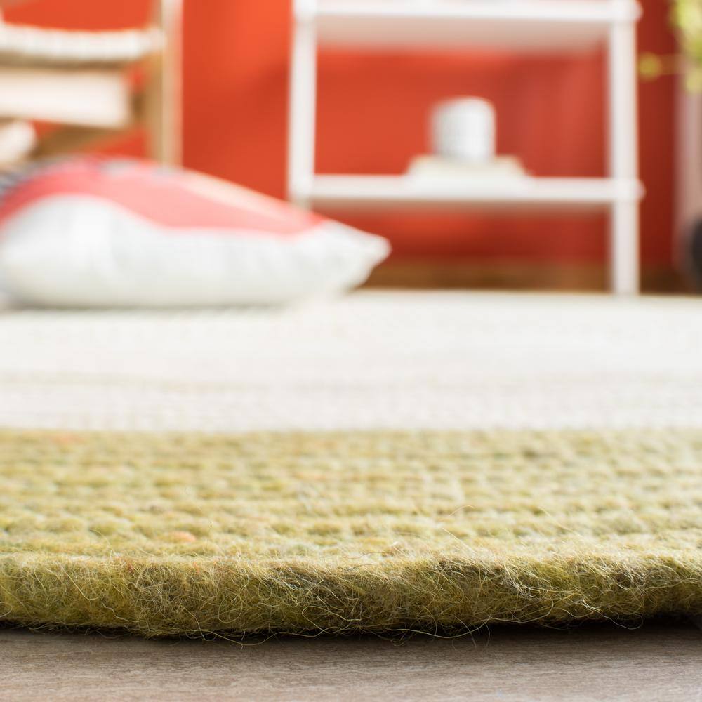 Handmade Green and Ivory Wool Oval Braided Area Rug 6' x 9'