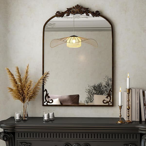 Bronze 24-inch wide x 36-inch high Arched bathroom mirror is wall-mountable and features a sculpted metal frame