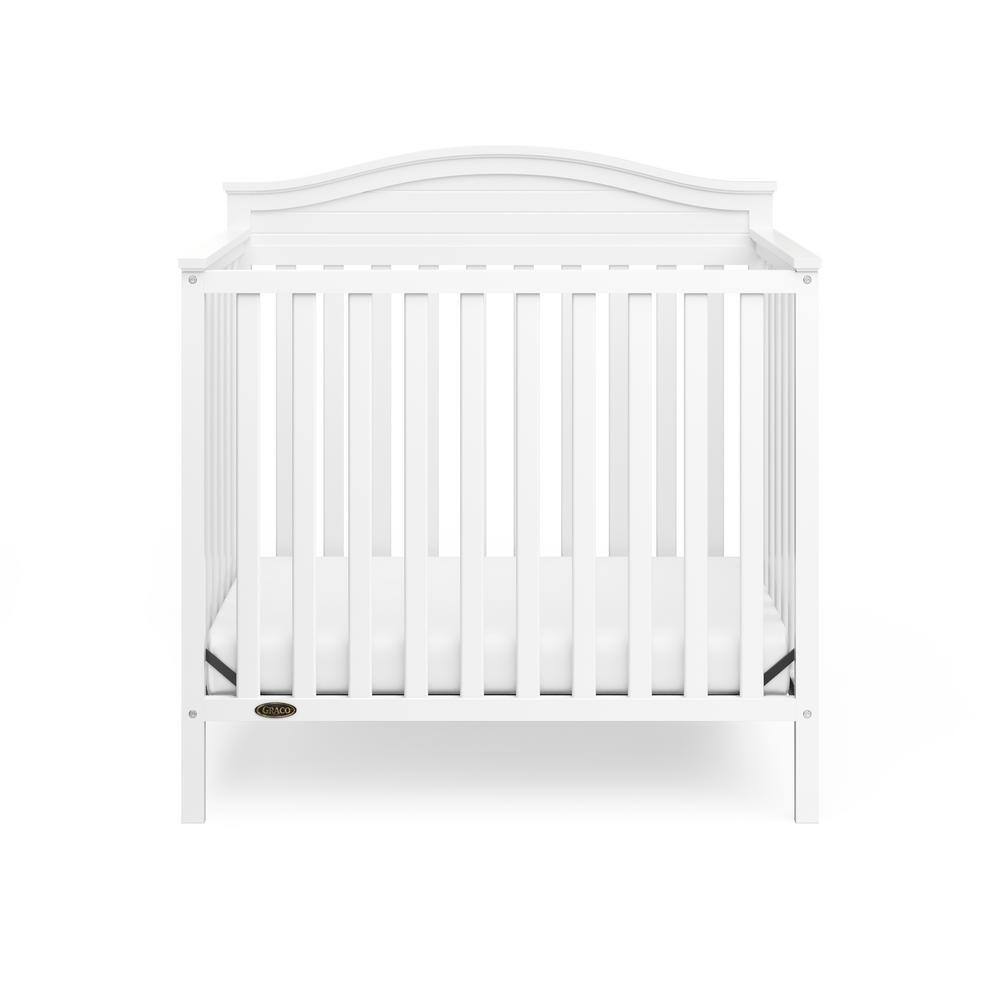 Stella White Pine Wood 4-in-1 Convertible Mini Crib with Foam Mattress