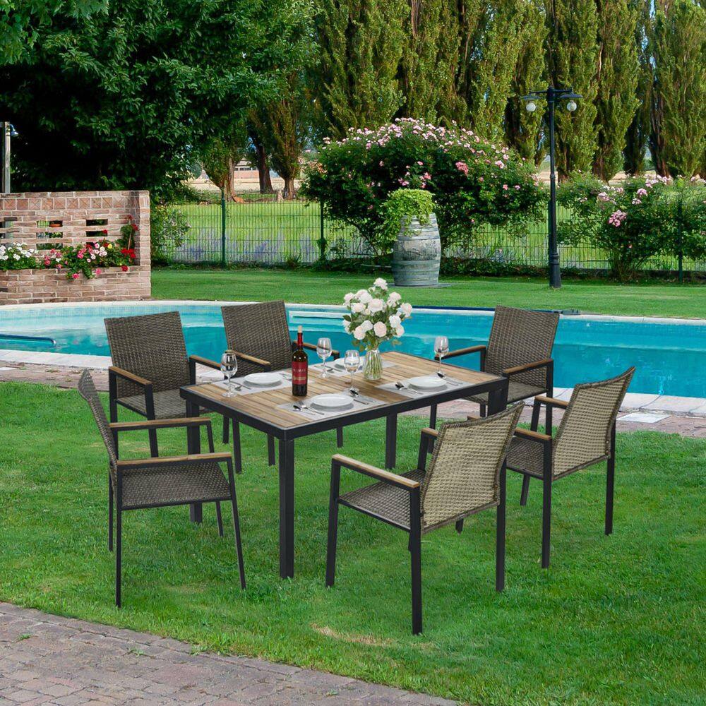 Outdoor dining set by a swimming pool with abundant greenery.