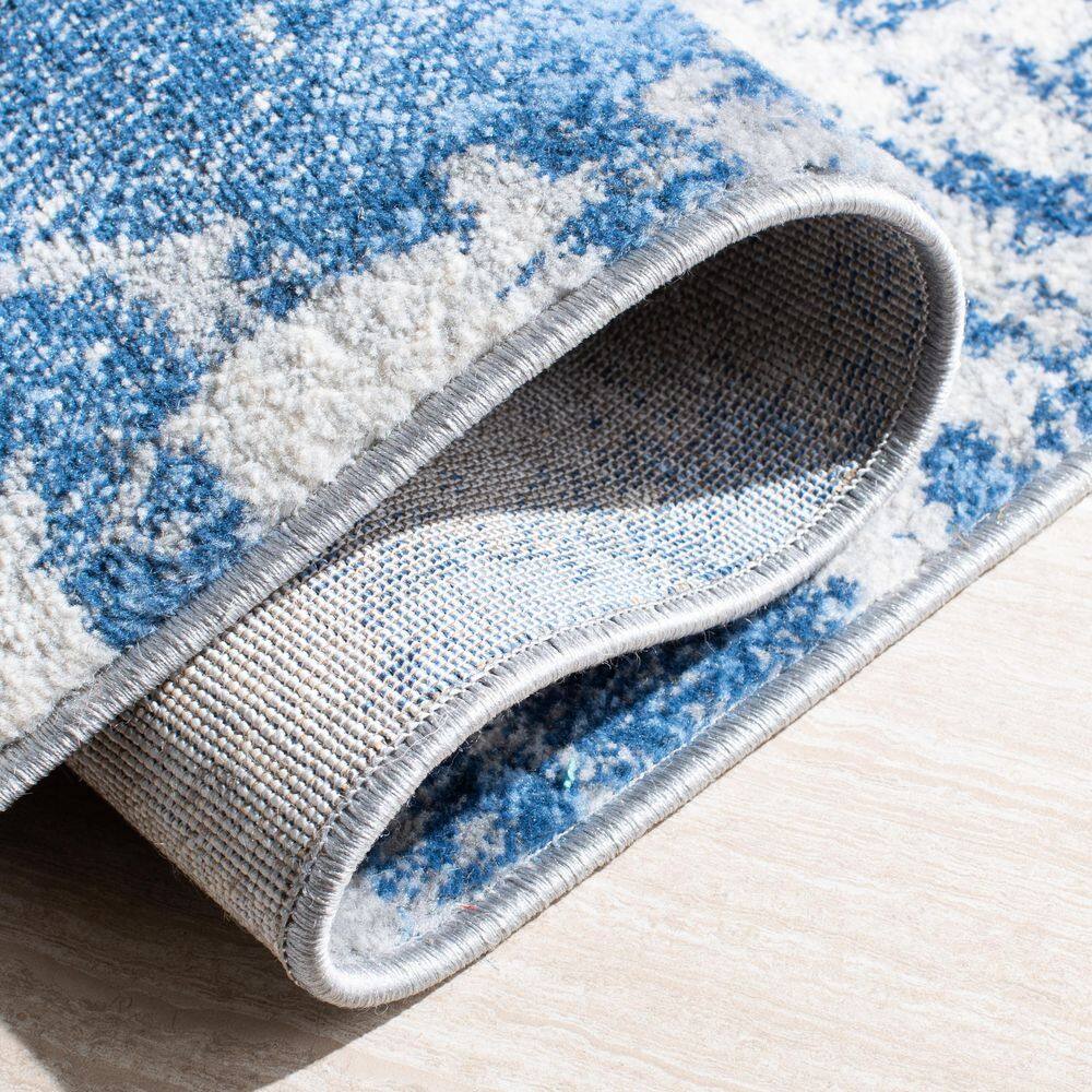 Blue and Ivory Abstract Synthetic Area Rug, 5'3" x 7'6"