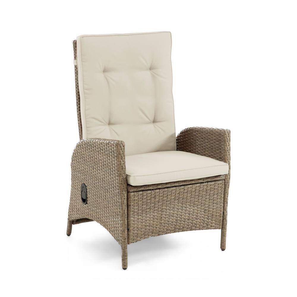 A single beige cushioned wicker reclining chair.