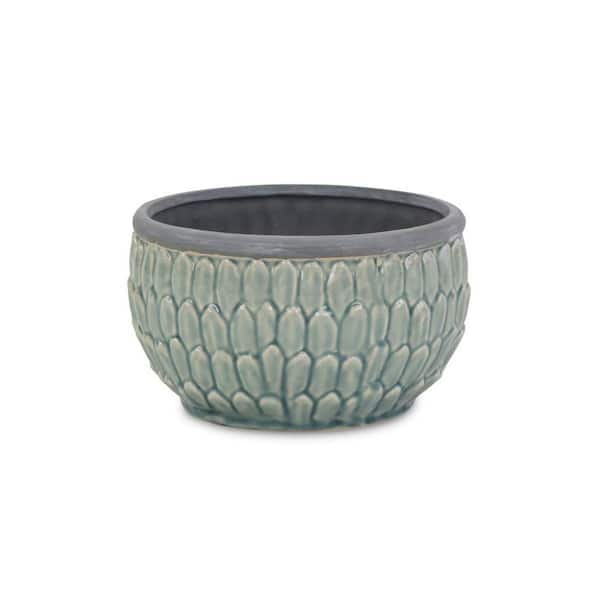 Round, blue ceramic pot with an overlapping leaf pattern