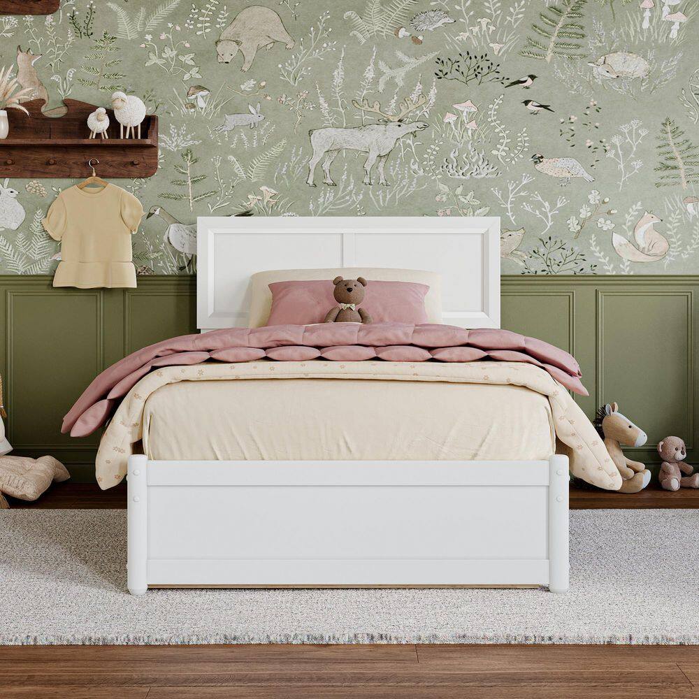 White twin bed with pink and cream bedding in a room.