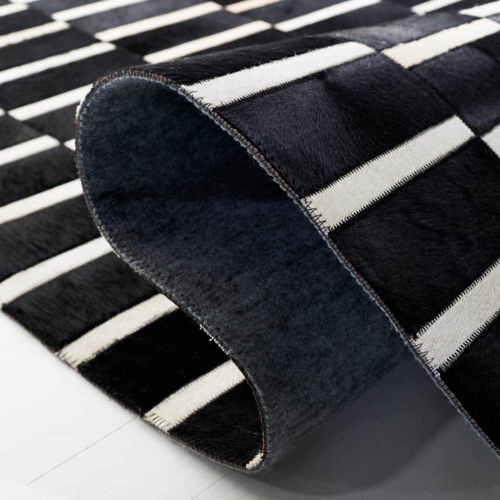 Handmade Black and Beige Geometric Cowhide Area Rug