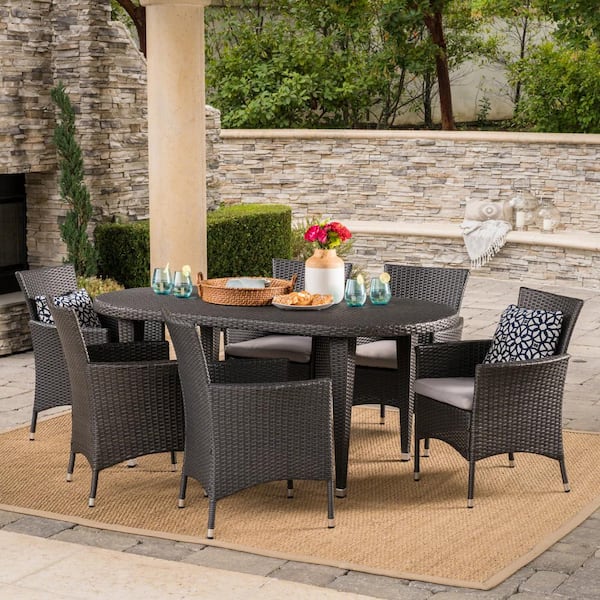 Noble House Jax Grey 7-Piece Faux Rattan Oval Outdoor Dining Set with Silver Cushions