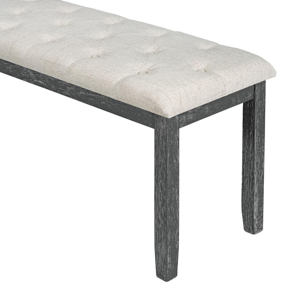 Upholstered dining bench with dark wood legs.