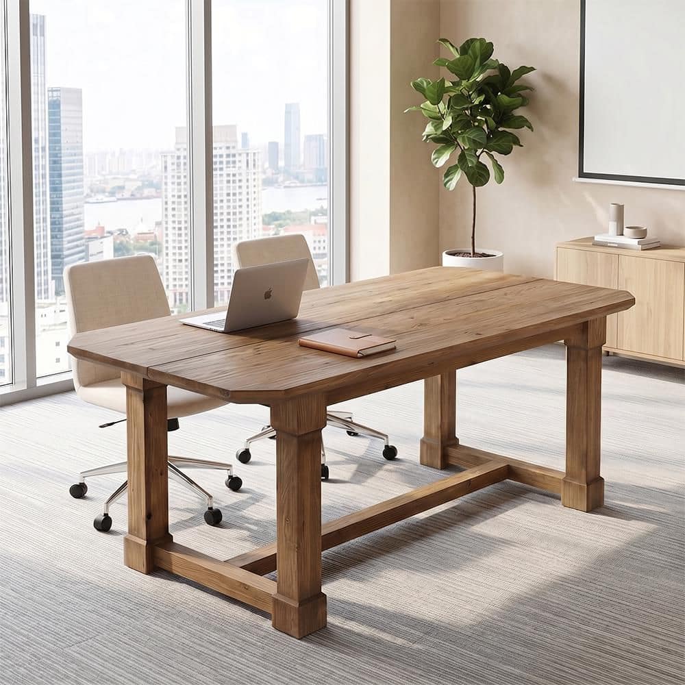 A rectangular brown wood desk in a bright room with large windows and a view of a city.
