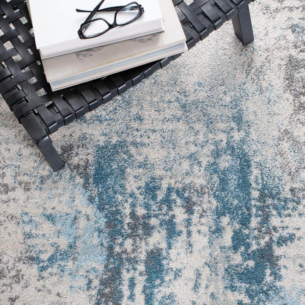 Ivory and Blue Abstract 9' x 12' Synthetic Area Rug
