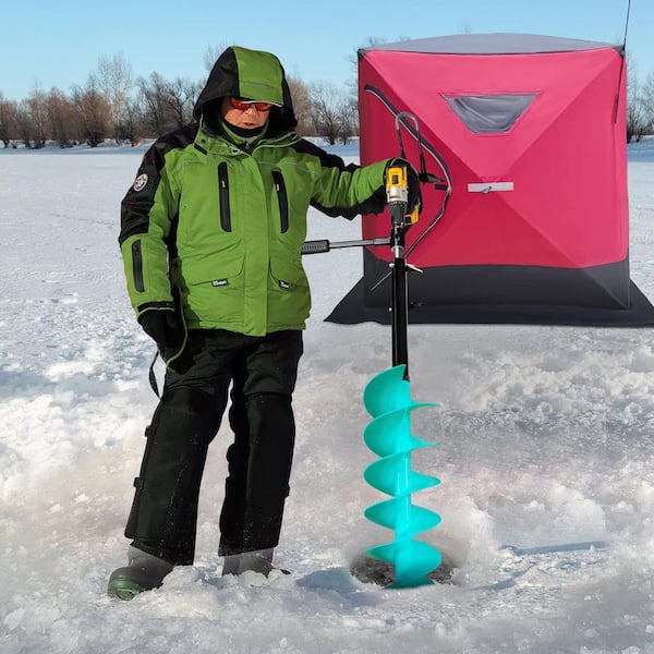 Clearing the ice fishing hole with a homemade ice scooper Stock