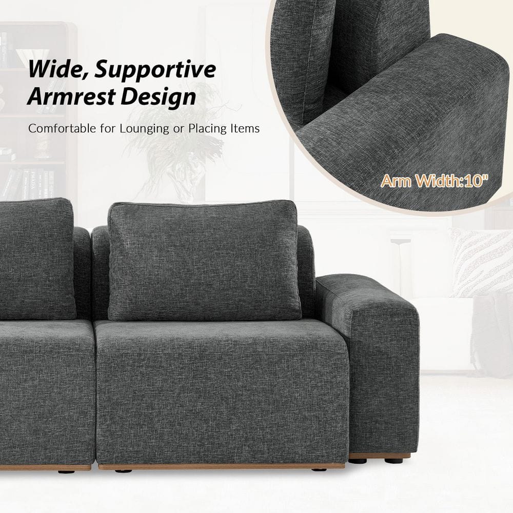 Close-up of the wide armrest and seat of a grey sectional sofa.