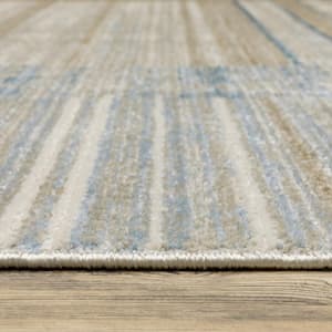 4' X 6' Blue Dark Blue Teal Grey Ivory Beige And Tan Geometric Power Loom Stain Resistant Area Rug With Fringe
