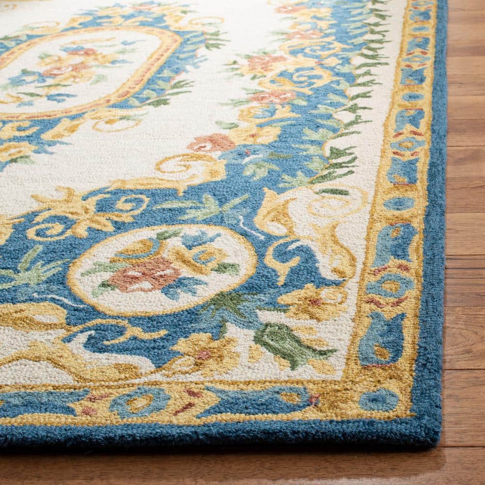 Handmade Cream and Blue Floral Wool Area Rug